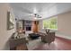 Comfortable living room with hardwood floors, a brick fireplace, and large windows at 323 Coral Ave, Goldston, NC 27252