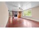 Spacious living room with brick fireplace and large windows offering natural light at 323 Coral Ave, Goldston, NC 27252