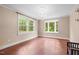 Bright living room featuring hardwood floors, a decorative chandelier, and large windows offering scenic views at 323 Coral Ave, Goldston, NC 27252