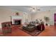 Comfortably furnished living room featuring a fireplace and an inviting seating area at 323 Coral Ave, Goldston, NC 27252