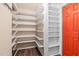 Pantry with ample open shelving and orange door at 323 Coral Ave, Goldston, NC 27252