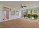 A sunroom that offers a tranquil escape, with wall-to-wall windows looking out onto lush greenery and a private yard at 323 Coral Ave, Goldston, NC 27252