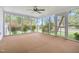 A spacious sunroom is surrounded by large windows, creating a bright, inviting space to relax and enjoy the outdoors at 323 Coral Ave, Goldston, NC 27252