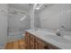 This bathroom is equipped with wood cabinets, double sinks, a large mirror, and a shower with glass doors at 3514 Shady Creek Dr, Durham, NC 27713