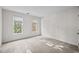 A clean bedroom design with neutral carpet, white walls and lots of natural light from the windows at 3514 Shady Creek Dr, Durham, NC 27713