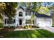 Charming two-story white home featuring a manicured lawn and two-car garage at 3514 Shady Creek Dr, Durham, NC 27713