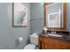 Stylish half bathroom with black marble countertop, elegant mirror, and modern fixtures at 3514 Shady Creek Dr, Durham, NC 27713