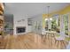 Open-concept living room with a fireplace, backyard access, and breakfast nook at 3514 Shady Creek Dr, Durham, NC 27713