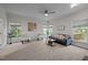 Bright living room featuring neutral decor, a cozy sofa, and large windows for natural light at 3514 Shady Creek Dr, Durham, NC 27713