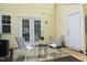 Cozy back patio with striped chairs, a small table, and convenient access to the house through double doors at 3623 Bison Hill Ln, Raleigh, NC 27604