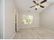 Spacious bedroom features a ceiling fan, large window, and plush carpeting at 3623 Bison Hill Ln, Raleigh, NC 27604