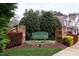 Bison Court community entrance sign with brick pillars, flower bed and lush green trees in the background at 3623 Bison Hill Ln, Raleigh, NC 27604