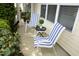 Charming front porch with striped chairs and well manicured shrubs at 3623 Bison Hill Ln, Raleigh, NC 27604