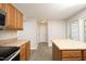 Bright kitchen features an island, stainless appliances, and access to the backyard through glass paneled door at 3623 Bison Hill Ln, Raleigh, NC 27604