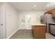 Open concept kitchen with island and stainless steel refrigerator at 3623 Bison Hill Ln, Raleigh, NC 27604