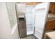 Stainless steel refrigerator with water dispenser and open doors shows ample storage at 3623 Bison Hill Ln, Raleigh, NC 27604