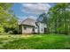 A wide-open and green backyard with beautiful forest views on a sunny day at 40 Holden Ct, Youngsville, NC 27596