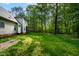 Expansive backyard with lush green lawn and mature trees, offering privacy and space for outdoor activities at 40 Holden Ct, Youngsville, NC 27596