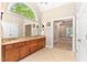 Bathroom featuring dual sinks, cabinets, large mirror and view of a bedroom at 40 Holden Ct, Youngsville, NC 27596