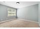 This bedroom features soft, neutral carpet, light-blue walls, and a window at 40 Holden Ct, Youngsville, NC 27596
