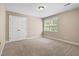 This bedroom offers carpet flooring, neutral-painted walls, and a double-door closet at 40 Holden Ct, Youngsville, NC 27596
