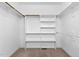 Walk-in closet with custom built-in shelving and racks for optimal storage at 40 Holden Ct, Youngsville, NC 27596