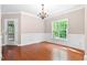 Dining room features hardwood floors, a chandelier, and access to back yard through the door at 40 Holden Ct, Youngsville, NC 27596