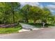 A long concrete driveway leading to a beautiful brick home surrounded by trees at 40 Holden Ct, Youngsville, NC 27596