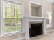 Close up of the fireplace with decorative mantel and views out to the back yard at 40 Holden Ct, Youngsville, NC 27596