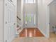 Grand foyer with hardwood floors, a striking front door and access to stairs and a powder room at 40 Holden Ct, Youngsville, NC 27596