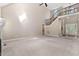 Open living area featuring carpet flooring, access to stairs, and lots of natural light at 40 Holden Ct, Youngsville, NC 27596