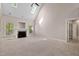 Spacious living room boasts a fireplace, vaulted ceiling with skylights, and neutral carpet at 40 Holden Ct, Youngsville, NC 27596