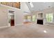Open-concept living room featuring a fireplace, a staircase, and views into the dining room at 40 Holden Ct, Youngsville, NC 27596