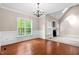 Bright living room featuring hardwood floors, a fireplace, and a large window offering scenic views at 40 Holden Ct, Youngsville, NC 27596