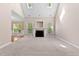 Bright living room featuring a fireplace and carpet flooring, with views into the dining room at 40 Holden Ct, Youngsville, NC 27596