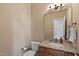 Charming powder room with granite vanity, toilet, and a decorative mirror at 40 Holden Ct, Youngsville, NC 27596