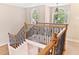 Elegant staircase with wooden railings and decorative iron spindles, bathed in natural light at 40 Holden Ct, Youngsville, NC 27596
