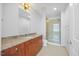 Bathroom featuring granite countertops, wood cabinets, and tile floors at 400 W North St # 502, Raleigh, NC 27603