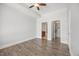 Spacious bedroom featuring hardwood floors, ceiling fan, and easy access to bathroom and walk-in closet at 400 W North St # 502, Raleigh, NC 27603