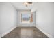 Bedroom with large window offering natural light, features wood-look flooring at 400 W North St # 502, Raleigh, NC 27603