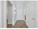 Hallway with wood floor, white walls, and multiple doors leading to other rooms at 400 W North St # 502, Raleigh, NC 27603