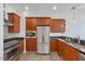 Modern kitchen with stainless appliances, wood cabinets, and granite counters at 400 W North St # 502, Raleigh, NC 27603