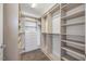 Spacious walk-in closet with custom shelving and wood floors at 400 W North St # 502, Raleigh, NC 27603