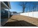 Spacious backyard with a white privacy fence and covered patio area at 403 Lagoon Ln, Mebane, NC 27302
