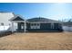 Backyard view showing a covered patio area and dark siding at 403 Lagoon Ln, Mebane, NC 27302