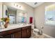 Well-lit bathroom with a vanity, toilet, and large mirror at 403 Lagoon Ln, Mebane, NC 27302