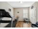 Bright bedroom featuring a treadmill, neutral paint, and a decorative sign at 403 Lagoon Ln, Mebane, NC 27302