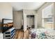 Bedroom with open closet, TV, and bed with floral comforter at 403 Lagoon Ln, Mebane, NC 27302