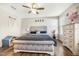 Bedroom with a large bed, dresser, ceiling fan, and wood-look floors at 403 Lagoon Ln, Mebane, NC 27302