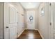 Bright entryway featuring wood flooring, a white front door with decorative glass, and neutral walls at 403 Lagoon Ln, Mebane, NC 27302